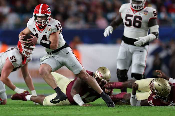 Dec 30, 2023; Miami Gardens, FL, USA; Georgia Bulldogs quarterback Gunner Stockton (14) rushes the ball against the Florida State Seminoles during the second half in the 2023 Orange Bowl at Hard Rock Stadium. Mandatory Credit: Nathan Ray Seebeck-USA TODAY Sports